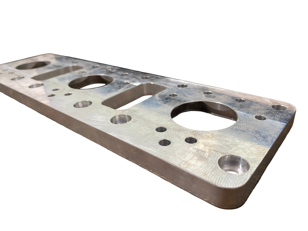Metal plate with multiple holes on a wooden surface
